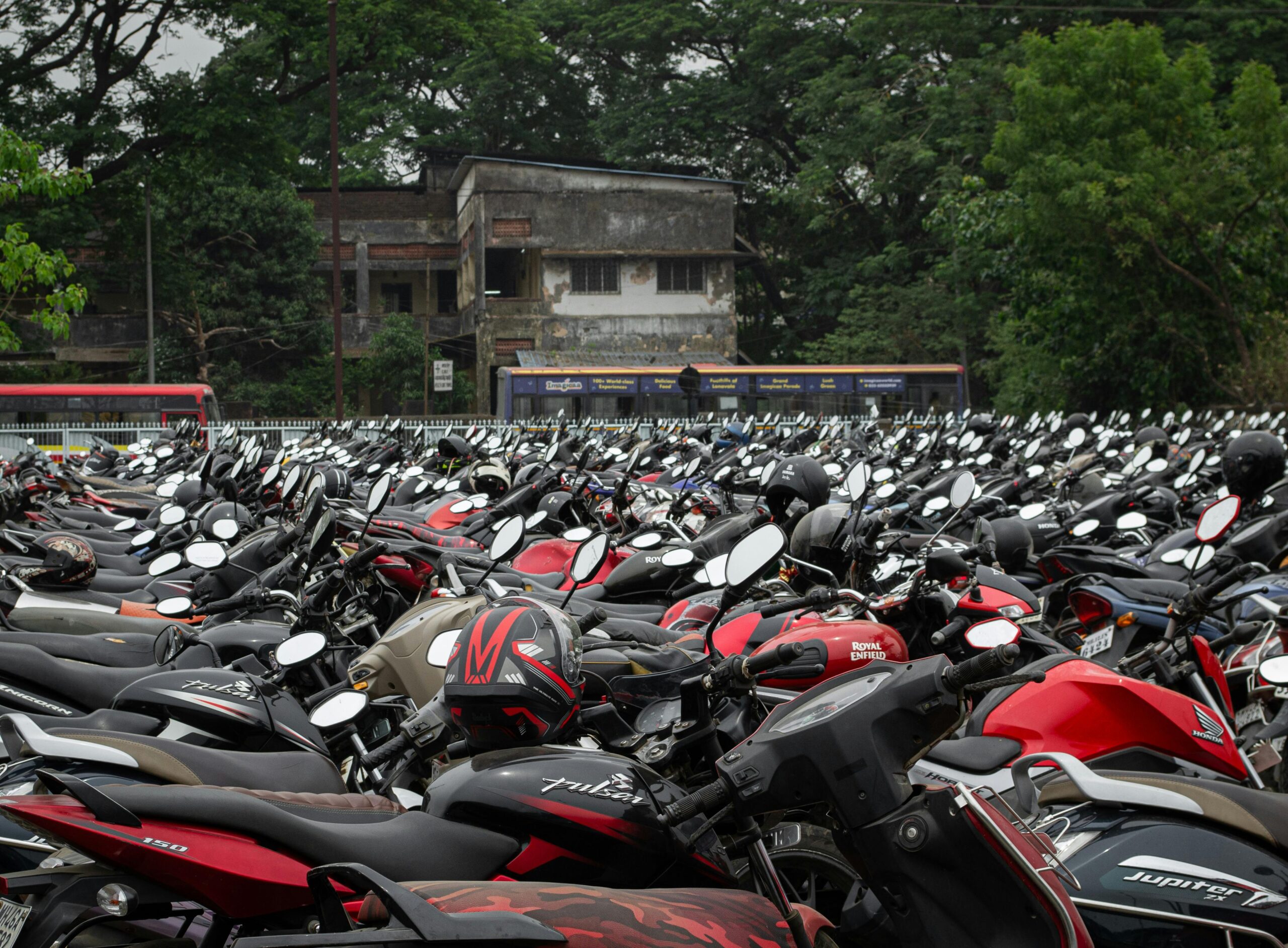Row of parked motorcycles in Navi Mumbai, India. Urban scene with dense vehicle presence.